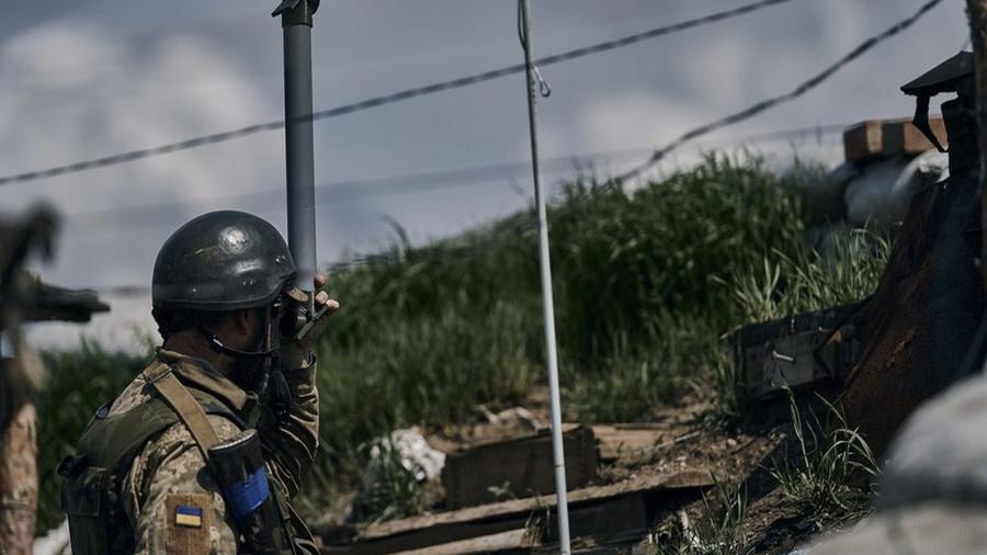 A Ukrainian soldier looks at the Russian positions through his periscope in a trench on the frontline in the village of New York, Donetsk region, Ukraine, Monday, April 24, 2023. (AP Photo/Libkos)